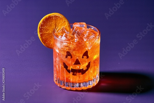 Halloween Jack O Lantern Orangeade Drink on Purple Background