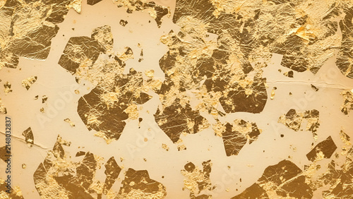 Foto Shimmering gold leaf flakes applied on a textured beige surface for an elegant a
