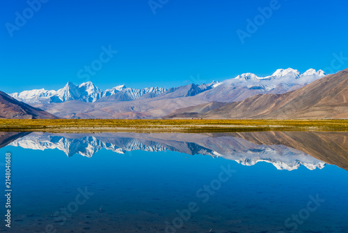 Ama Drime Peak in the Himalayas, Tibet Autonomous Region, China. The snow-covered summit rises above the Tibetan Plateau, creating a spectacular alpine landscape under clear blue skies.