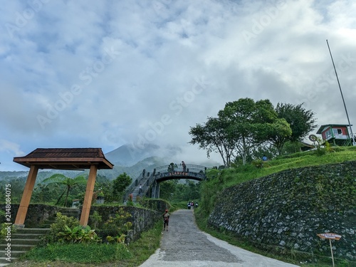 Bild auf Leinwand Beautiful View of Klangon Hill with Mount Merapi Background and Iconic Bridge in