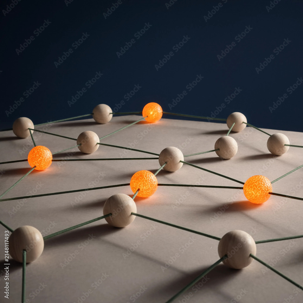 Obraz premium Network structure of wooden spheres and connecting rods with glowing orange active nodes. Physical metaphor for neural networks and data transmission. Complex technological system concept