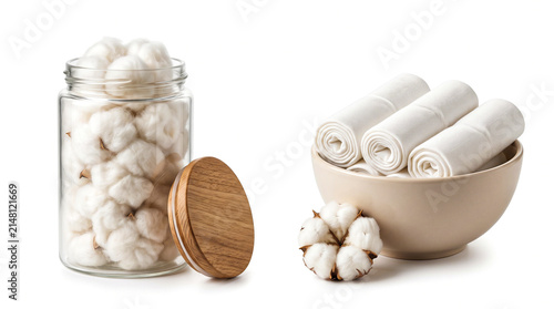 Cotton bolls in a glass jar and rolled cotton fabric in a bowl isolated on white background