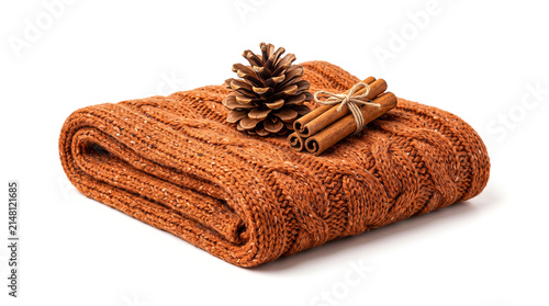 Cozy orange knitted blanket with pinecone and cinnamon sticks isolated on white background