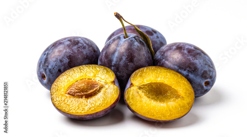 Fresh ripe plums with one cut in half isolated on white background