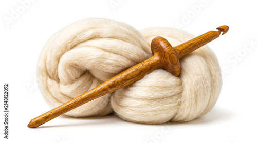 Handmade wooden drop spindle with wool roving isolated on white background