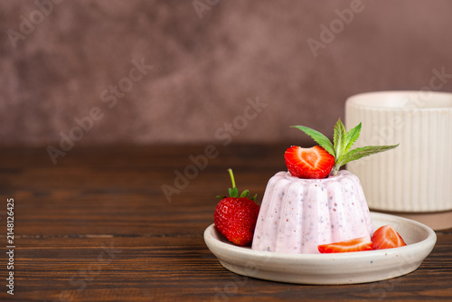 Clean eating healthy dessert made with cottage cheese, chia seeds, fresh berries and mint leaves on a wooden table. Copy space.