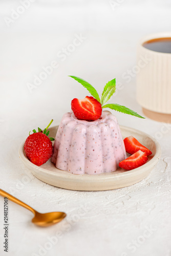 Fresh strawberry chia jelly dessert with cottage cheese and cup of coffee on a light table. Vertical orientation.