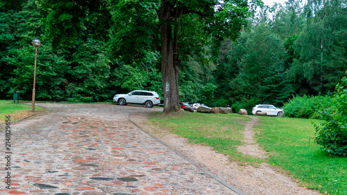 Cars parked near a path in a green area with trees and stones on a cloudy day The Augustow Canal on the Vistula River and the Neman River in Belarus Grodno Region on July 25, 2026.