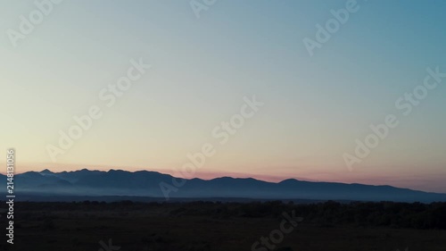 Morning mist drifting over mountain valley landscape