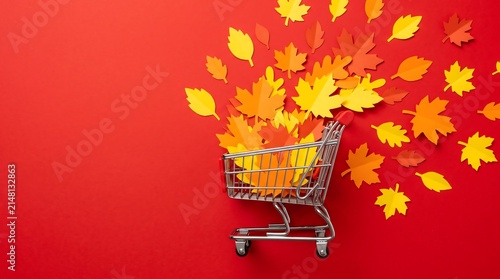 Autumn fall season shopping cart full of dry leaves background with shopping consumerism seasonal commerce promotion discount business marketing background colorful background
