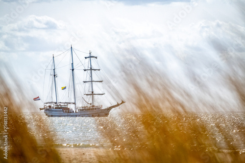 The Marker Wadden nature reserve in Lake Marker in the Netherlands, Flevo province. Artificial archipelago, a 3-masted sailing ship sails past