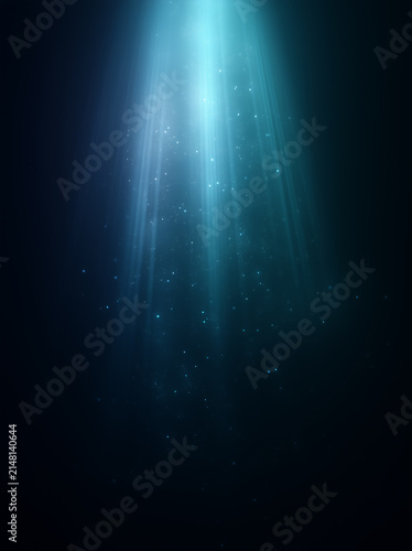 Vertical abstract background with bright blue light ray. Glowing spotlight and floating dust particles on dark black backdrop