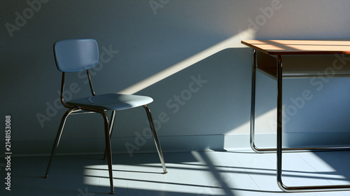 detention. Empty school chair with beam of cold daylight beside plain wall, discipline and silent reflection concept, lifestyle magazines.
