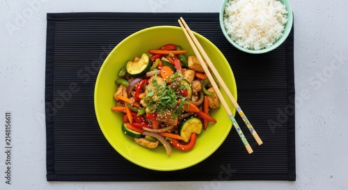 Healthy Asian Stir-fry with Vegetables, Tofu, and Rice on Black Mat