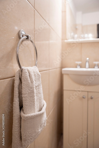 Clean towel hanging on ring in bathroom