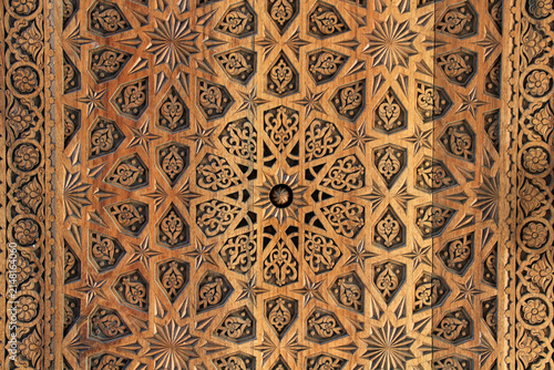 An example of Uzbek handicrafts. Geometric and floral motifs feature on the wooden door leaf.