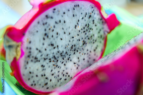 Food Series : Fresh white dragon fruit sliced in half revealing juicy flesh with tiny black seeds.