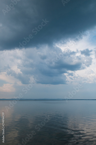 Uvildy lake in July with dramatic cloudy sky above, South Ural, Russia