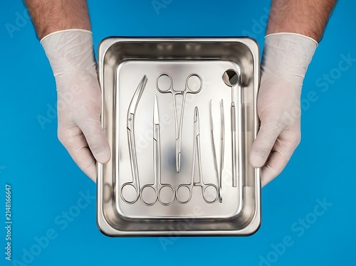 Sterile surgical instruments tray held by medical professional in gloves with instruments hospital healthcare equipment surgical procedure stainless clinical operation practitioner