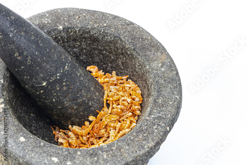 Foto Traditional handcrafted stone mortar and pestle made of granite filled with smal