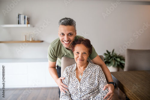 Man and Senior Woman Smiling Together at Home