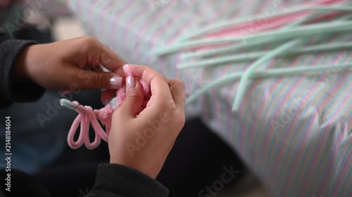 Child's hands twisting pipe cleaner for diy art project during a creative workshop close of handmade crafting up