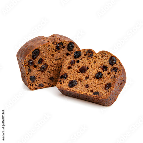Sliced loaf of rich, spiced fruit cake with dried raisins and a moist texture.