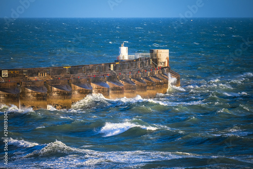 Quadro su tela Storm Waves Crashing Against Concrete Breakwater