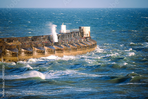 Foto Storm Waves Crashing Against Concrete Breakwater