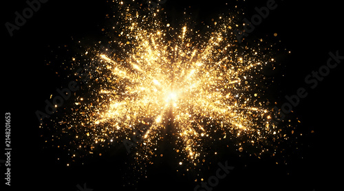 A bright golden explosion of light particles and glowing dust isolated on a black background creating a festive celebration or magical energy effect
