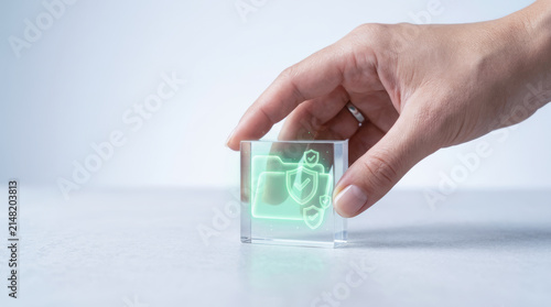 Hand holding transparent cube with glowing folder and shield icons representing quality audit and secure data management concept