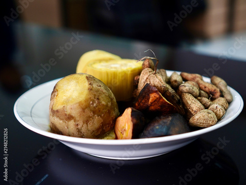Close-up view of assorted boiled traditional Indonesian street food snacks served together on a white ceramic plate