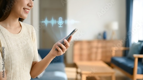 Woman interacts with a digital voice assistant interface glowing above her handheld smartphone in a bright modern living room.