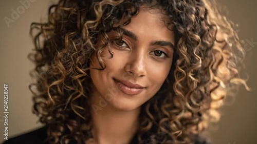 Close-up Portrait of a Young Woman with Curly Hair Displaying Natural Beauty in a Soft Digital Photography Style