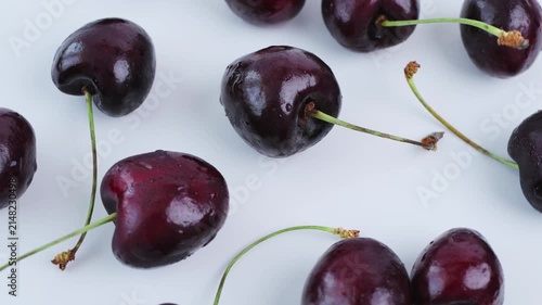 Fresh cherries on white background. Cherries showcase juicy seasonal harvest with natural stems, perfect for healthy food advertising, grocery promotion, organic branding and fresh produce. 4k