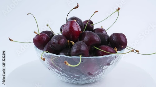 Ripe dark cherry in glass bowl isolated on white background, fresh cherry collection highlights organic fruit quality, juicy produce, seasonal harvest, premium nutrition for healthy lifestyle projects