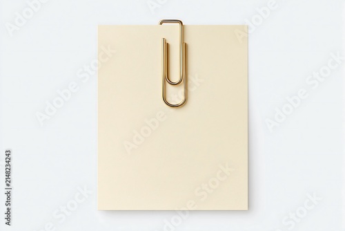 Blank cream paper note card with gold paperclip top view stationery mockup with copy space