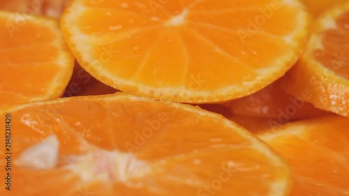 Macro shot of fresh orange slices, showing juicy citrus texture and vibrant color.