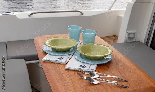 Dining Table Setting on a Yacht Deck. Specialized shatterproof tableware for yacht dining. 