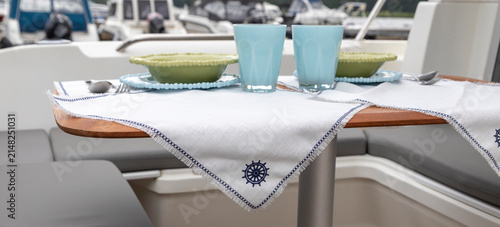 Dining Table Setting on a Yacht Deck. Specialized shatterproof tableware for yacht dining. 
