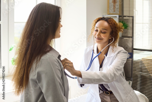 Bild auf Leinwand Doctor uses stethoscope for patient examination