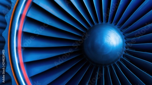 Abstract close-up of a powerful jet engine turbine with metallic blue blades and radial geometry, creating a futuristic technological background for aerospace, engineering, energy and innovation theme
