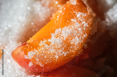 Cooking apricot jam with sugar.  Orange color apricot berries bubbling in a pot during the simmering process for a fresh homemade confiture. Apricots jam making process. Shallow depth of field.