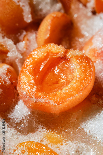 Cooking apricot jam with sugar. Freshly cooked, hot apricot jam.  Shallow depth of field.