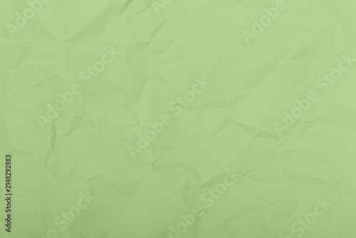 Light green crumpled paper texture background