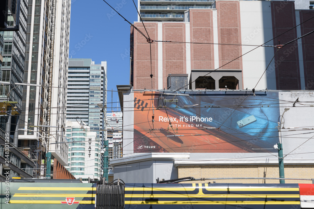 Fototapeta premium Apple Inc mural advertising at southeast corner of Spadina Av and King St W, Toronto (Find My feature)