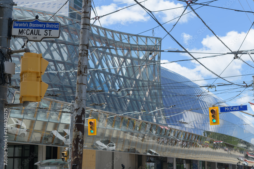 Fototapeta premium abstract defocused view of Art Gallery of Ontario with street sign of McCaul St and Dundas St W, Toronto