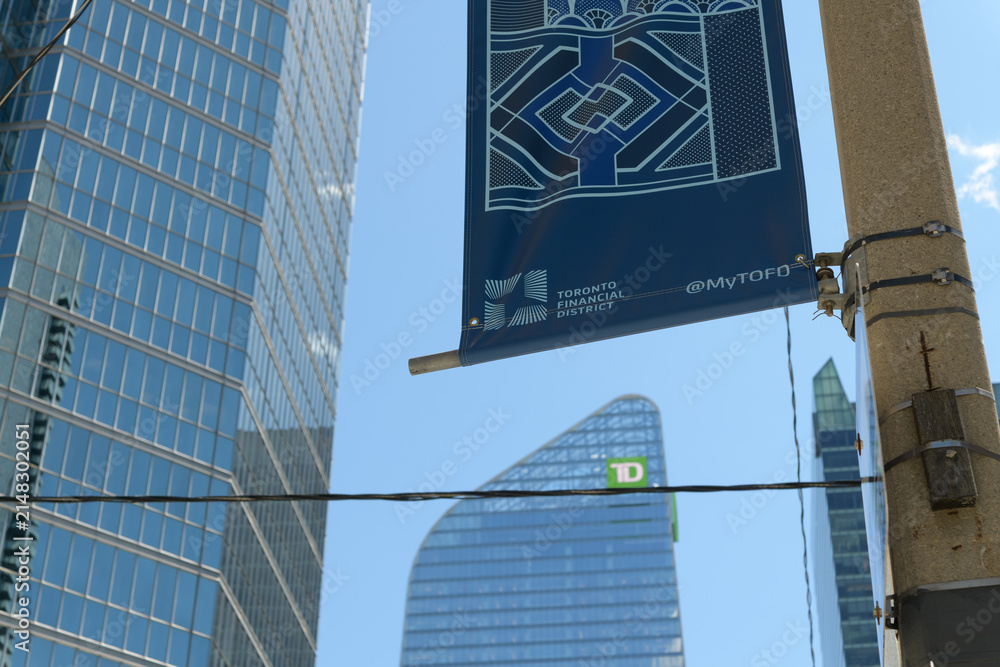 Fototapeta premium looking south (& up) on Simcoe St to Financial District Toronto BIA banner and TD Terrace near King St W