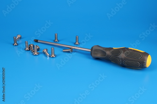 Screwdriver with an insulated handle for installing equipment. Soft focus. Close-up. Macro. 