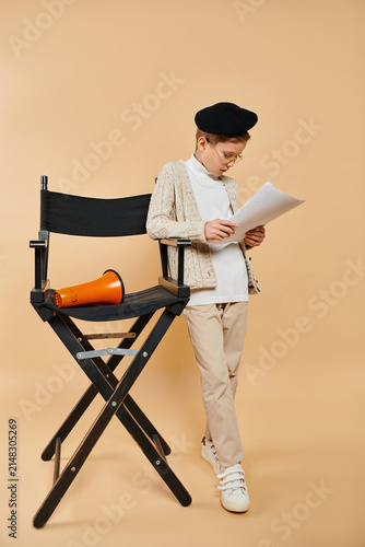Obraz na plátne Little boy brings dreams to life as an aspiring film director in his stylish out